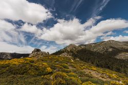 Breathtaking white clouds above hills with greenery