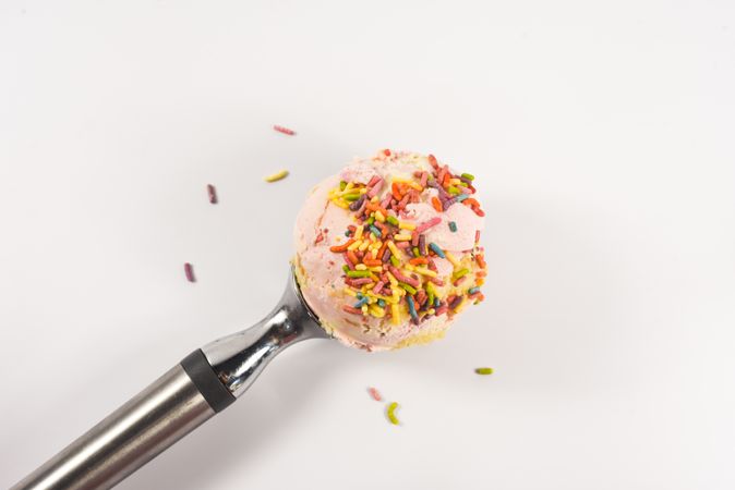 Pink ice cream scoop with sprinkles