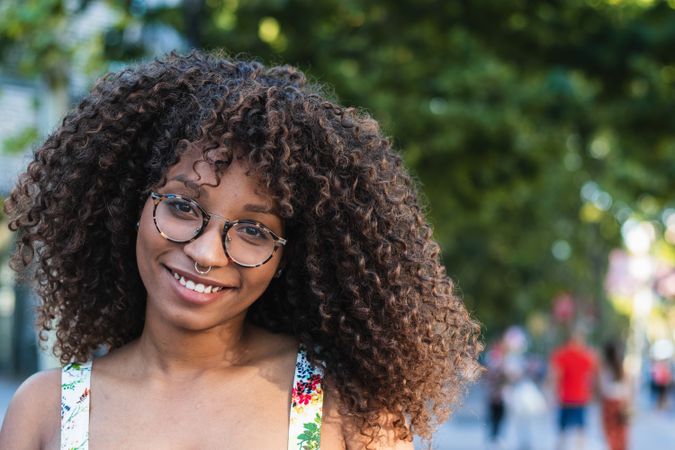 Glad woman looking at camera in park
