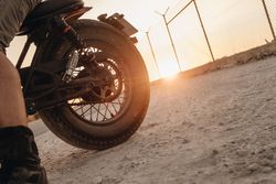 Male riding moto on asphalt