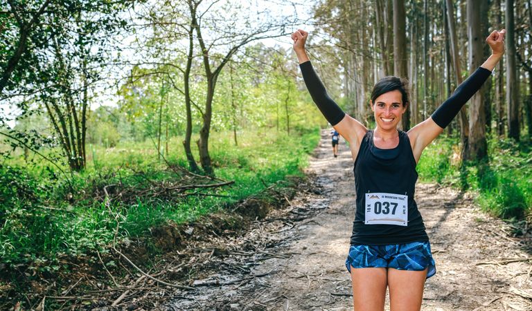 Young woman winning trail race