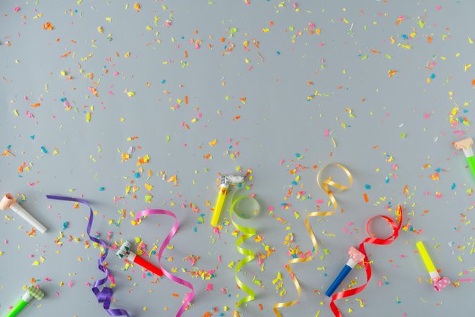 Confetti and colorful streamings on grey background