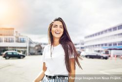 Radiant smiling woman outside in parking lot on overcast day with copy space 0gpYl5