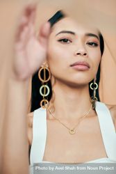 Young woman looking at camera with statement earrings 5ngpM4