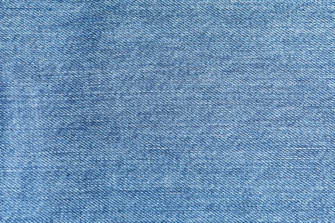 Texture of blue jeans as background, space for text