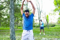 Commitment and Consistency: Black Trainer Leading Fitness Class with Copy Space