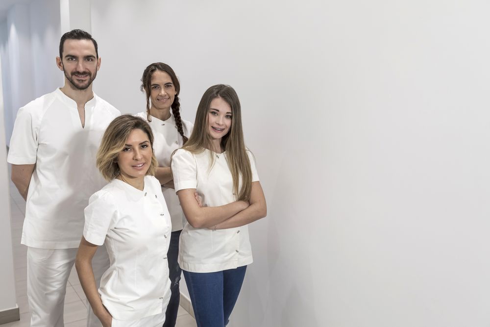 Portrait of confident happy group of medical staff standing in bright office