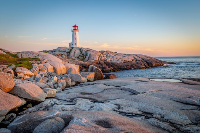 Lighthouse on rocks during sunset in Halifax, Nova Scotia, Canada