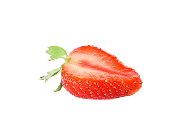 Half of strawberry isolated on light background. Summer sweet fruits and berries