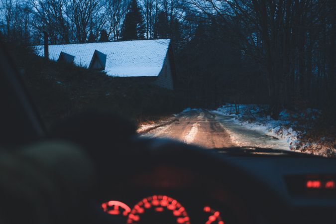 Crop hand driving car in winter village