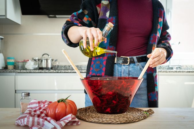 Crop woman preparing vegetable salad