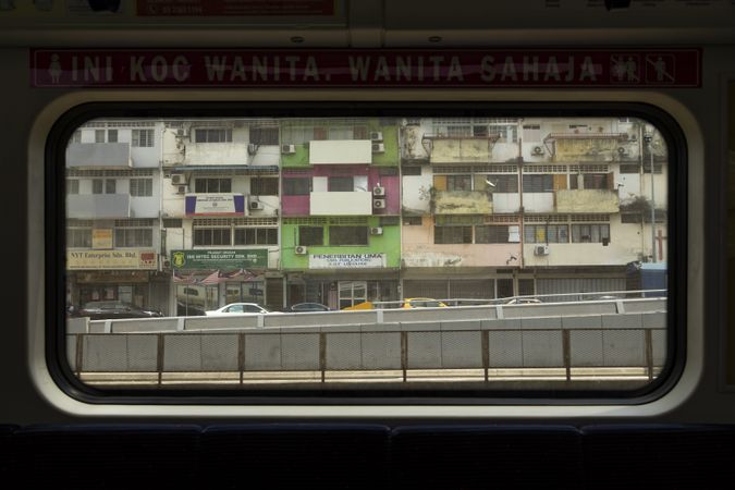 Exterior from inside of the KTM train line, in Kuala Lumpur, Malaysia, heading towards Batu Caves