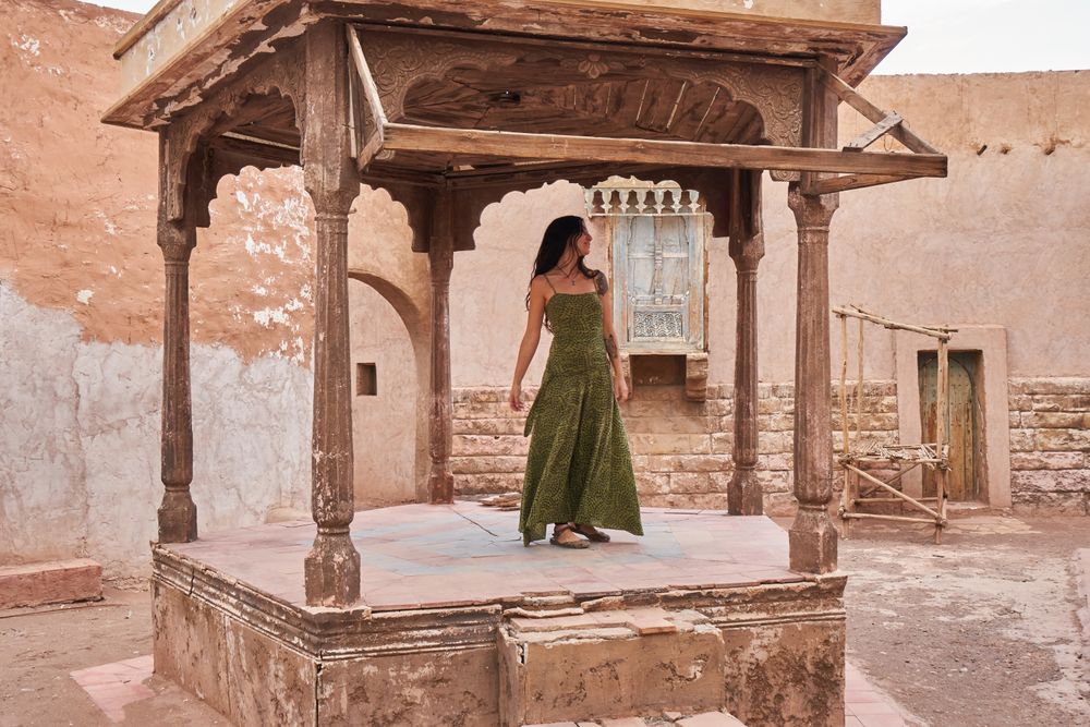 Woman dancing on street stage between ancient buildings