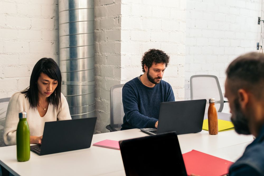 Group of multiracial people working with laptop in a coworking