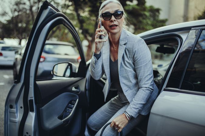 Female executive traveling to office in a luxurious car