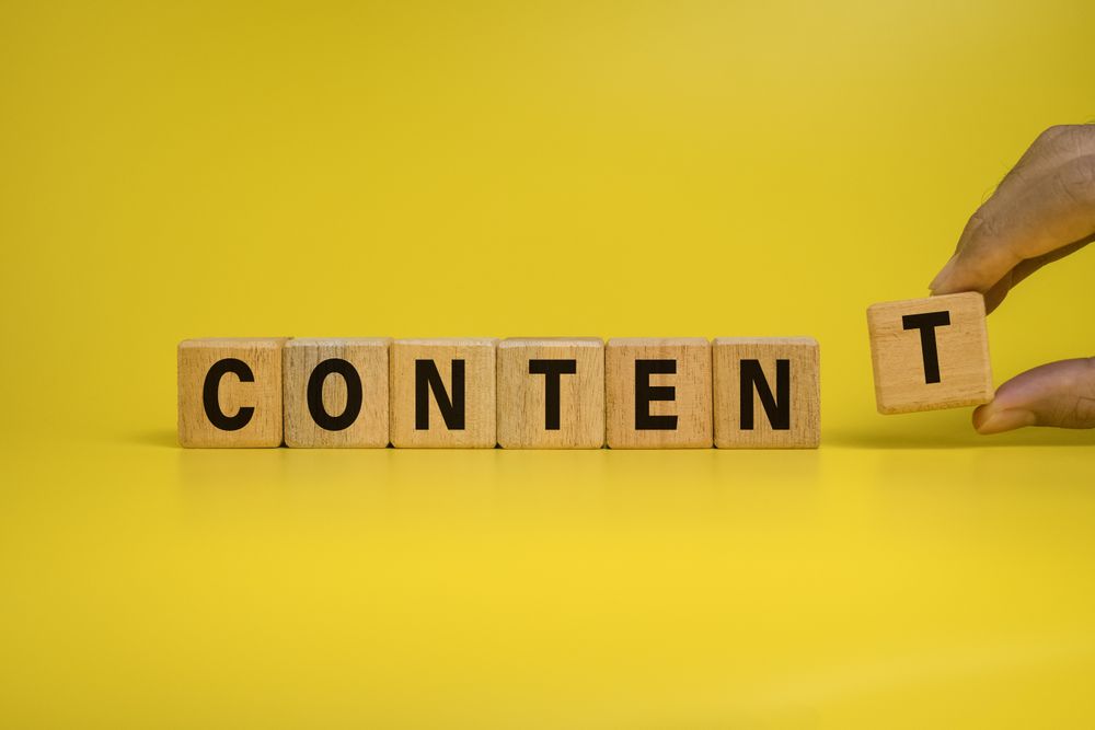 male hand put wooden blocks with content word isolated on yellow background
