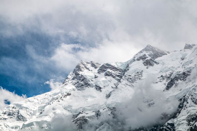 Mountains behind clouds on sunny day in Fairy Meadows, Pakistan