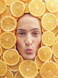Female face with pouting lips in orange pieces