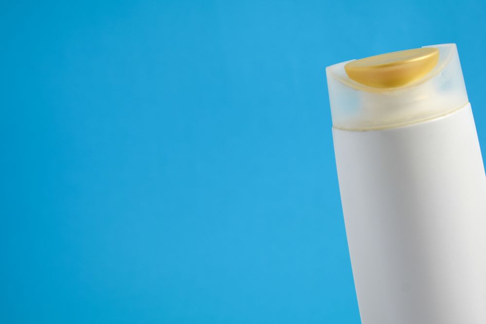 Body wash or shampoo against blue background
