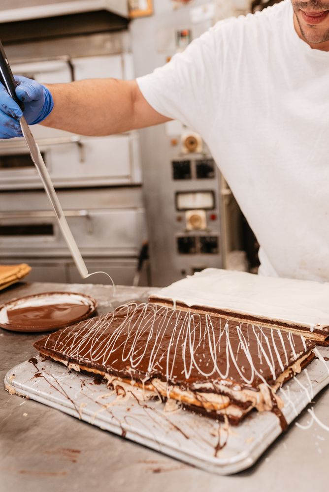 Anonymous pastry cook decorating sweet cake