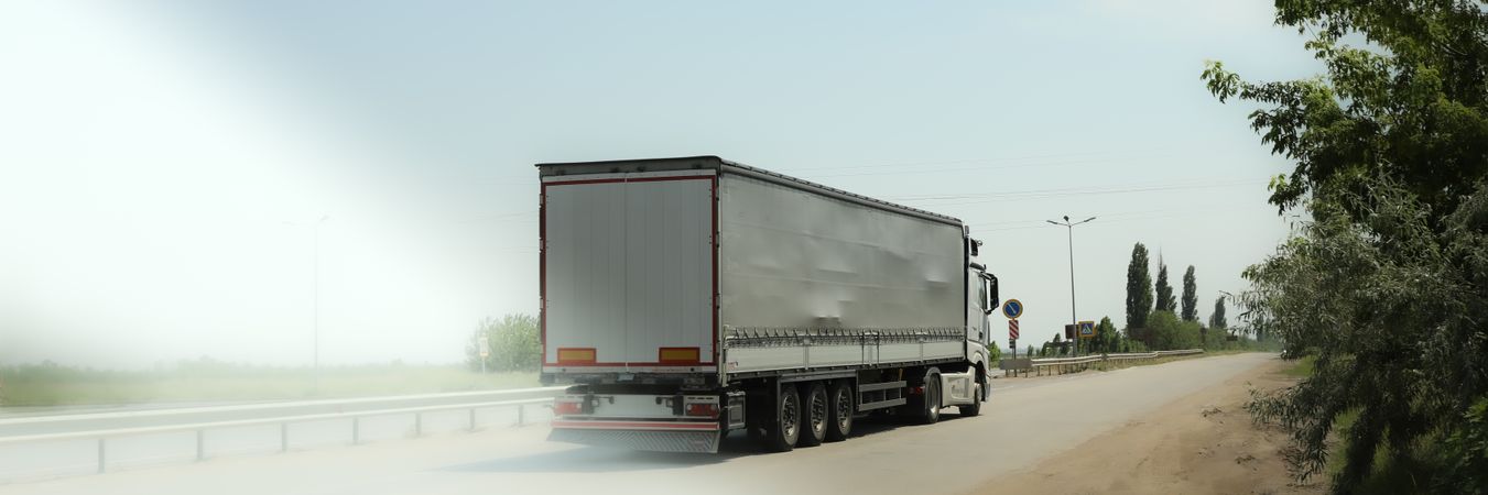 Truck rides on the highway. Trucker work