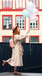 Woman in streets with balloons