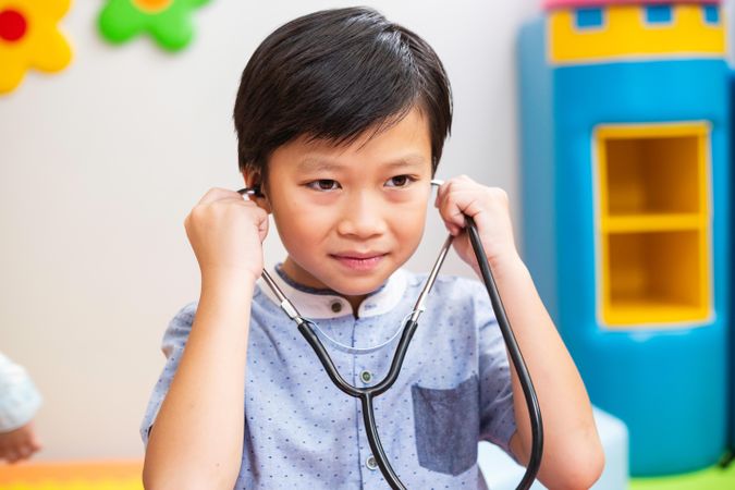 Cute Asian boy playing doctor