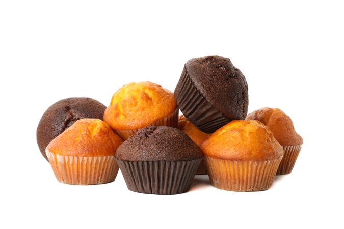 Delicious tasty muffins isolated on light background