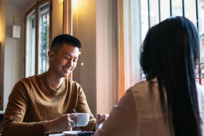Asian man on a date in a coffee shop