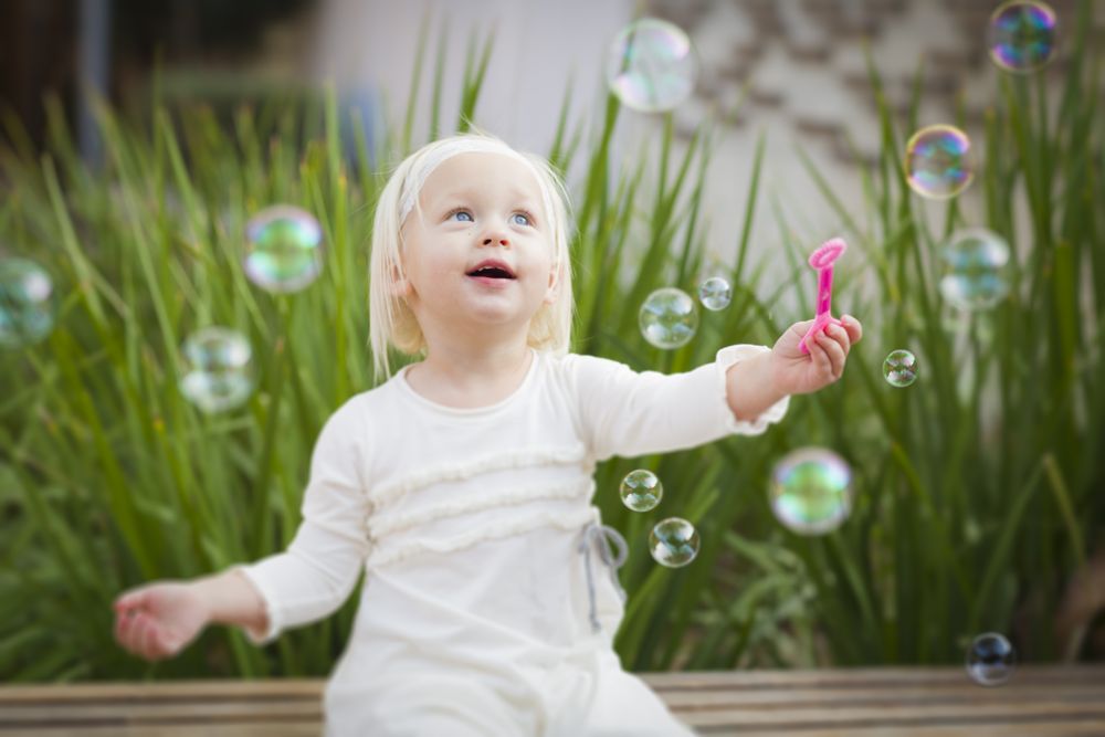 Adorable Little Girl Having Fun With Bubbles