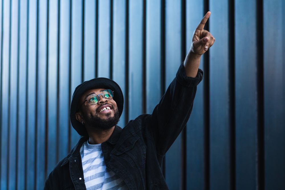 Excited Black man pointing up