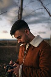 Portrait of a photographer taking photos in the countryside