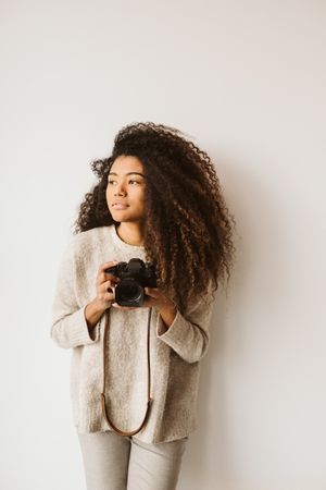 Cheerful Black woman with camera