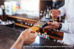 Customer making payment using credit card at bar 48BgZY
