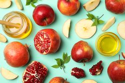 Flat lay top view of autumnal fruit scattered on mint background