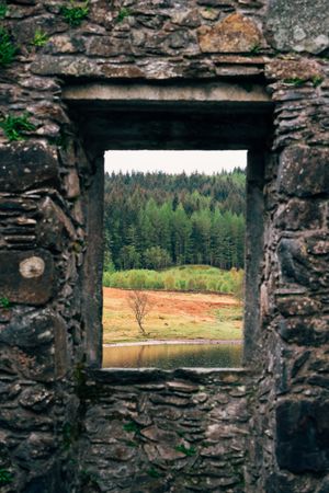 Aged stone window frame with landscape