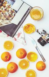 Arrangement of oranges and photo camera