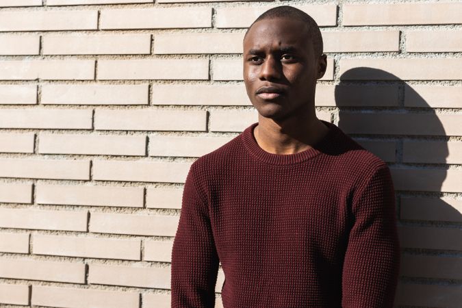 Young Black male standing near billet wall
