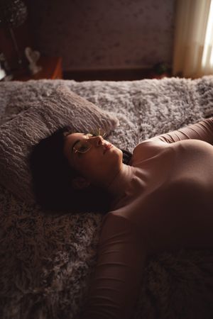 Young woman lying on bed