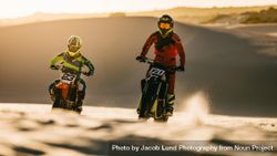 Professional dirt bikers racing on sand dunes bEODo5