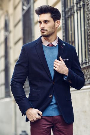 Attractive man in the street wearing elegant suit looking to his side