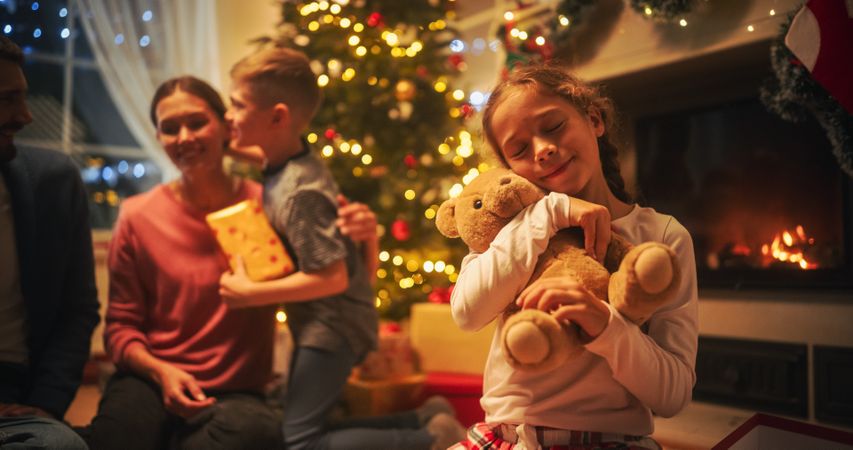 Loving Young Parents Giving Gifts to Their Children on Christmas Eve.