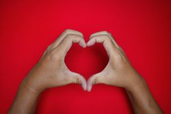 love gesture on red background