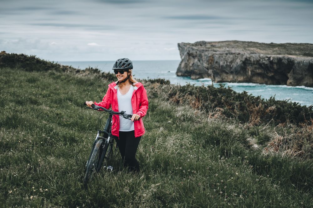 Female bicyclist on rocks