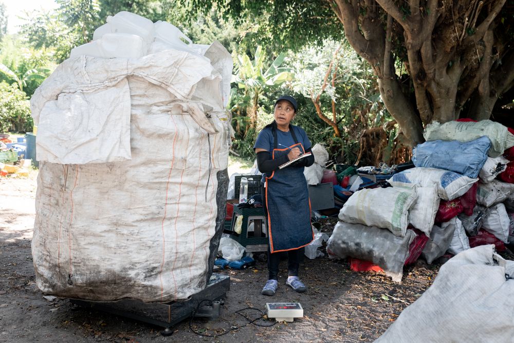 Hispanic Woman Recording Recycled Plastic Weighing