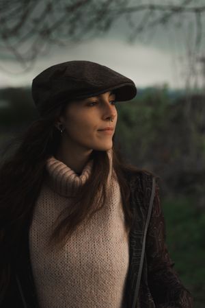 Young woman in warm clothes in forest