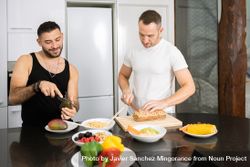 Male couple preparing vegetables and bread for lunch 5oXAz4