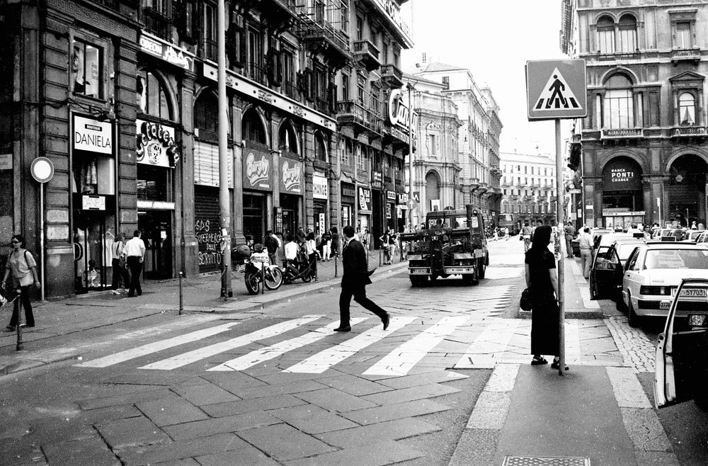 Milan, Italy - June 1999 - Monochrome image of man crossing street in Milan