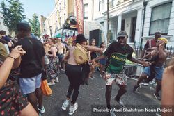 London, England, United Kingdom - August 25th, 2019: Men dance among a crowd at street festival 4Zerr5