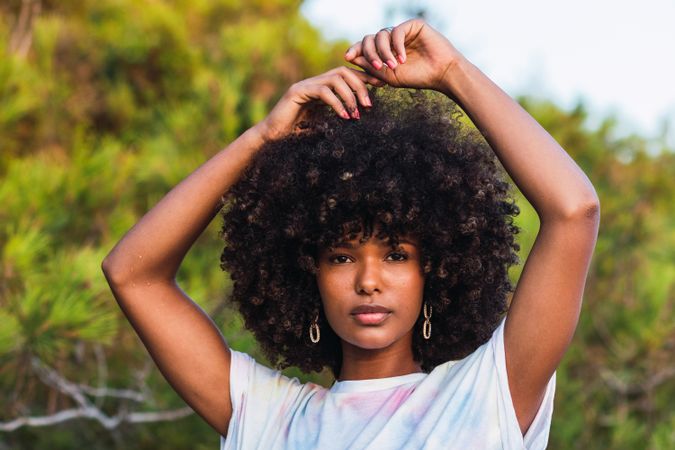 Calm Black woman with Afro hairstyle in nature